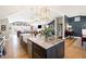 The kitchen features an island, stainless steel appliances, and an open layout at 8175 Main St, Woodstock, GA 30188