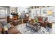 Spacious living room featuring leather furniture, a patterned rug, and access to the outdoor area at 8175 Main St, Woodstock, GA 30188