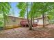 Exterior backyard featuring a cozy wooden deck and mature trees providing lots of shade at 1024 Stone Mill Run, Lawrenceville, GA 30046