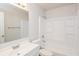 Clean bathroom featuring a tub and shower combo with white tiling and chrome fixtures at 1024 Stone Mill Run, Lawrenceville, GA 30046