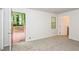 Bright carpeted bedroom with door to deck and large window at 1024 Stone Mill Run, Lawrenceville, GA 30046