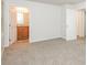 Carpeted bedroom featuring access to an ensuite bathroom and a separate closet at 1024 Stone Mill Run, Lawrenceville, GA 30046