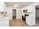 Bright kitchen features white cabinets, stainless steel appliances, and modern countertops at 1024 Stone Mill Run, Lawrenceville, GA 30046