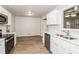 Modern kitchen with white cabinets, stainless steel appliances, and a view of the dining area at 1024 Stone Mill Run, Lawrenceville, GA 30046