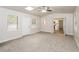 Open living room with neutral paint, new carpet, and a ceiling fan at 1024 Stone Mill Run, Lawrenceville, GA 30046