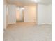 Spacious, carpeted living area with neutral walls, offering a view into the hallway at 1024 Stone Mill Run, Lawrenceville, GA 30046