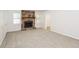 Carpeted living room featuring a stone fireplace, windows, and neutral paint throughout at 1024 Stone Mill Run, Lawrenceville, GA 30046