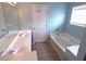Spacious bathroom featuring double sinks, a large soaking tub, and tile flooring at 126 Wellbrook Ne Ct, Conyers, GA 30012