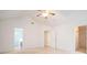 Spacious primary bedroom with carpet flooring, ceiling fan, and access to the bathroom and closet at 126 Wellbrook Ne Ct, Conyers, GA 30012