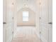 Bright bedroom featuring neutral walls and carpet flooring, with a window at the far end of the hall at 126 Wellbrook Ne Ct, Conyers, GA 30012