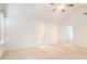 Bedroom with vaulted ceilings, carpet flooring, a ceiling fan, and two windows at 126 Wellbrook Ne Ct, Conyers, GA 30012
