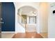 Entryway with hardwood floors, white staircase, and views into the brightly lit living area at 126 Wellbrook Ne Ct, Conyers, GA 30012