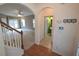 Entryway featuring an arched doorway to the living room, a staircase, and a view of the powder room at 126 Wellbrook Ne Ct, Conyers, GA 30012