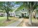 View of the two-story home with green siding and a sidewalk leading up to the front door at 126 Wellbrook Ne Ct, Conyers, GA 30012