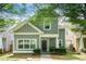 Charming two-story home featuring gray siding, a covered front porch, and well-maintained landscaping at 126 Wellbrook Ne Ct, Conyers, GA 30012