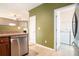 Well-equipped kitchen with stainless steel dishwasher and access to laundry room at 126 Wellbrook Ne Ct, Conyers, GA 30012