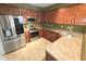 Well-lit kitchen featuring stainless steel appliances, wood cabinets, and light countertops at 126 Wellbrook Ne Ct, Conyers, GA 30012