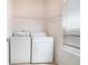 Functional laundry area featuring a washer, dryer, and shelving for storage at 126 Wellbrook Ne Ct, Conyers, GA 30012