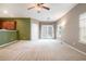 Bright living room with neutral carpet, ceiling fan, and access to outdoor patio via double doors at 126 Wellbrook Ne Ct, Conyers, GA 30012