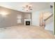 Spacious living room with fireplace and lots of natural light open to kitchen and entrance at 126 Wellbrook Ne Ct, Conyers, GA 30012