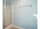 Bright shower area with glass door, next to a towel bar and blue accent wall at 126 Wellbrook Ne Ct, Conyers, GA 30012