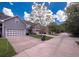 Neighborhood street scene featuring well-maintained lawns, driveways, and a row of townhomes at 126 Wellbrook Ne Ct, Conyers, GA 30012