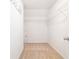 Bright walk-in closet with carpeted floor and wire shelving for optimal storage and organization at 126 Wellbrook Ne Ct, Conyers, GA 30012