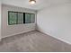 This bedroom features neutral carpet and a large window at 1480 Pine Log Ne Rd # D, Conyers, GA 30012