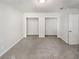 This bedroom features neutral carpet and two walk-in closets at 1480 Pine Log Ne Rd # D, Conyers, GA 30012