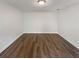 Spacious bedroom featuring hardwood floors, neutral walls, and modern ceiling trim at 1480 Pine Log Ne Rd # D, Conyers, GA 30012