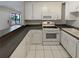This kitchen features white cabinets and modern appliances at 1480 Pine Log Ne Rd # D, Conyers, GA 30012