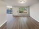 Bright living room features hardwood floors, ample seating, and a large window at 1480 Pine Log Ne Rd # D, Conyers, GA 30012