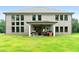The manicured backyard has a covered patio, grilling area, and the home's brick facade at 3012 Flat Shoals Rd, Conyers, GA 30094