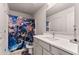 Bathroom with a single sink vanity and anime-themed shower curtain and matching toilet seat cover and rug at 3012 Flat Shoals Rd, Conyers, GA 30094