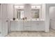 Bright bathroom featuring a double vanity with gray cabinets and stone-look tile floors at 3012 Flat Shoals Rd, Conyers, GA 30094