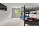 Bedroom with large windows and a gray metal bunkbed with desk underneath at 3012 Flat Shoals Rd, Conyers, GA 30094