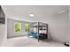Neutral toned bedroom with carpet, large windows, and a gray metal bunkbed at 3012 Flat Shoals Rd, Conyers, GA 30094