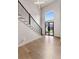 Bright entryway with a grand staircase, hardwood floors, and a modern front door offering a warm welcome at 3012 Flat Shoals Rd, Conyers, GA 30094