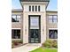 Elegant front entrance featuring a modern, black-framed glass door and decorative stone accents at 3012 Flat Shoals Rd, Conyers, GA 30094