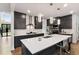Modern kitchen features an island with seating, stainless appliances, and gray cabinets at 3012 Flat Shoals Rd, Conyers, GA 30094