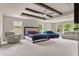 Spacious main bedroom with beamed ceiling, large windows, and ample seating at 3012 Flat Shoals Rd, Conyers, GA 30094
