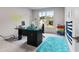 Well-lit home office with a large window, a modern desk and bright blue rug at 3012 Flat Shoals Rd, Conyers, GA 30094