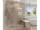 Luxurious walk-in shower with marble-look tile, glass enclosure, and a built-in bench at 3012 Flat Shoals Rd, Conyers, GA 30094