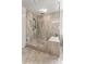 Luxurious walk-in shower with marble-look tile, glass enclosure, and a built-in bench at 3012 Flat Shoals Rd, Conyers, GA 30094