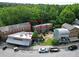 Aerial view of mixed-use property with parking, greenery, and a surrounding neighborhood at 9071 Selborne Ln, Chattahoochee Hills, GA 30268