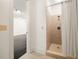 This bathroom features a tile shower with neutral-toned tiles and a shower curtain at 9071 Selborne Ln, Chattahoochee Hills, GA 30268