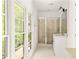 Bathroom featuring a glass shower and double sink vanity at 9071 Selborne Ln, Chattahoochee Hills, GA 30268
