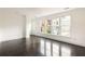 Bright bedroom featuring hardwood floors and natural light at 9071 Selborne Ln, Chattahoochee Hills, GA 30268