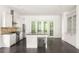 Bright kitchen with a granite island and stainless steel appliances at 9071 Selborne Ln, Chattahoochee Hills, GA 30268
