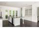 Bright kitchen with a granite island and stainless steel appliances at 9071 Selborne Ln, Chattahoochee Hills, GA 30268